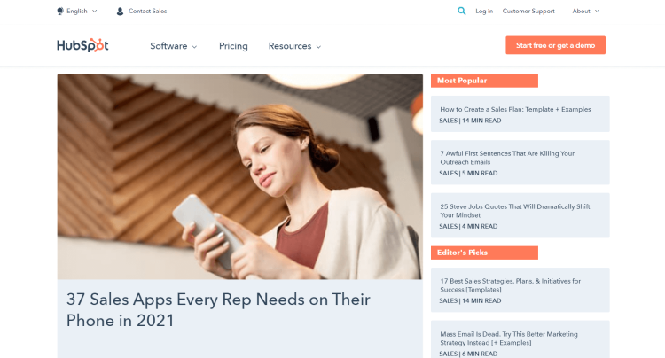 Business Blog The HubSpot and its home page with woman choosing sales apps on her phone.