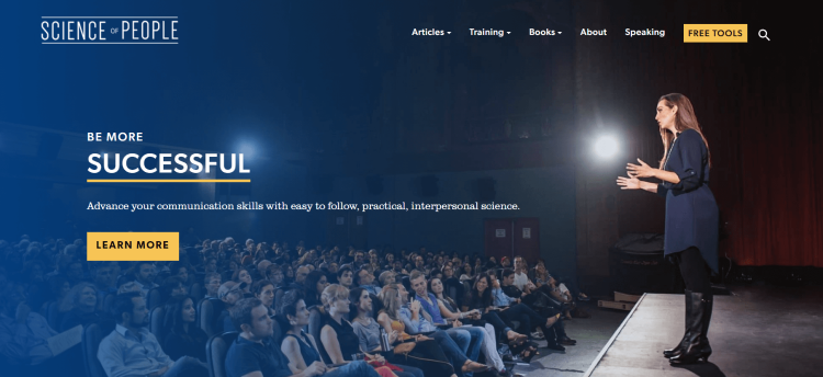Business blog, Science of People, home page with woman standing on the stage motivating audience.