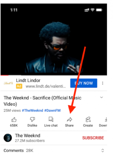 After selecting the video you want to share, click on the“Share arrow icon next to the Like, Dislike, and Live Chat buttons.