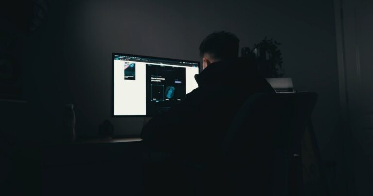 Web Designer sitting at a table at night designing website