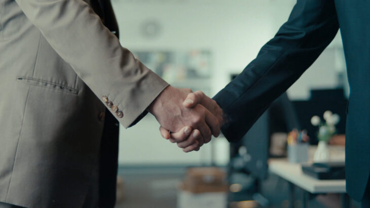 Two businessmen shaking hands after closing a deal