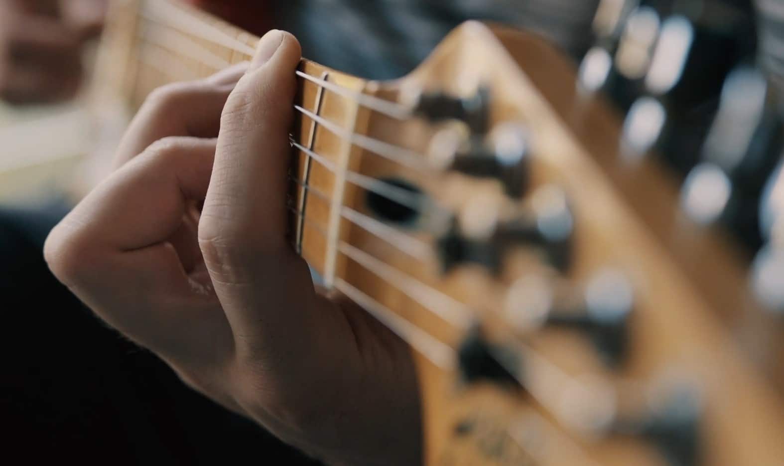 A guy is playing an electric guitar