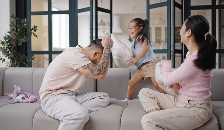 Young family is having a pillow fight