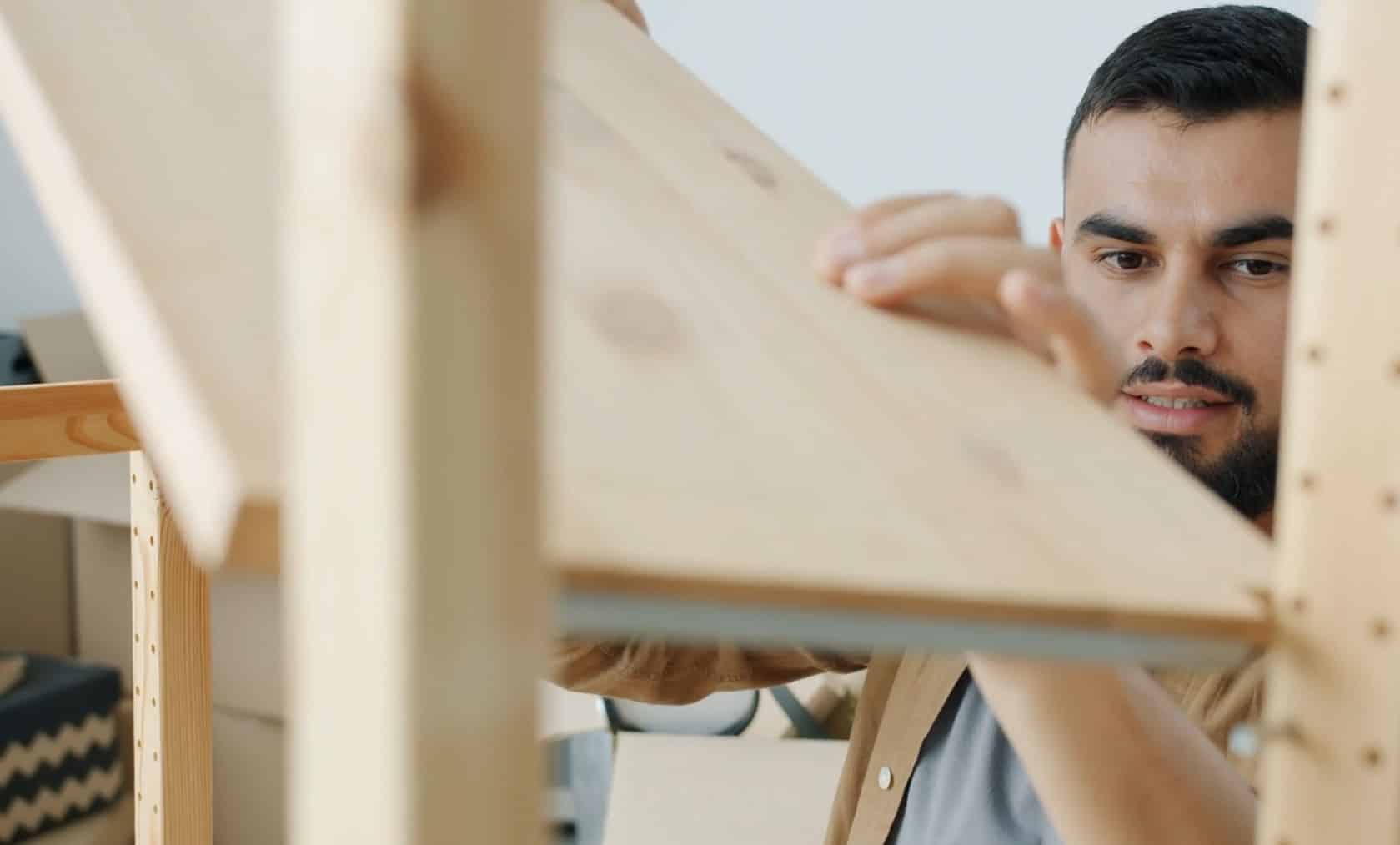 A guy is building a shelf