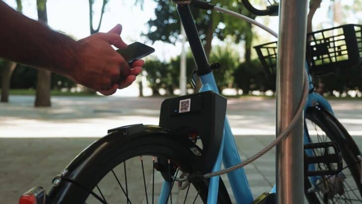 A man is scanning a QR code on a bicycle