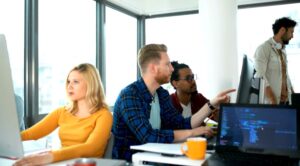 Close-up view of a group of programmers working together