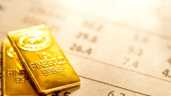 Gold bars on a financial chart, highlighting the rising interest in commodities as a 2025 investment strategy