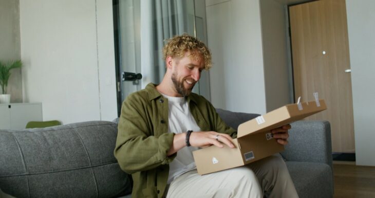 A satisfied customer unboxing his delivery