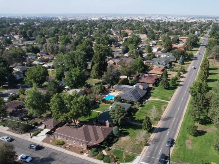 Aerial shot of Denver suburbs showing tree-lined streets and detached homes