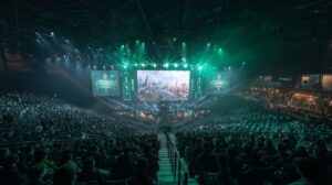 Packed esports stadium with a massive screen displaying gameplay and green stage lighting during Riyadh Masters 2025