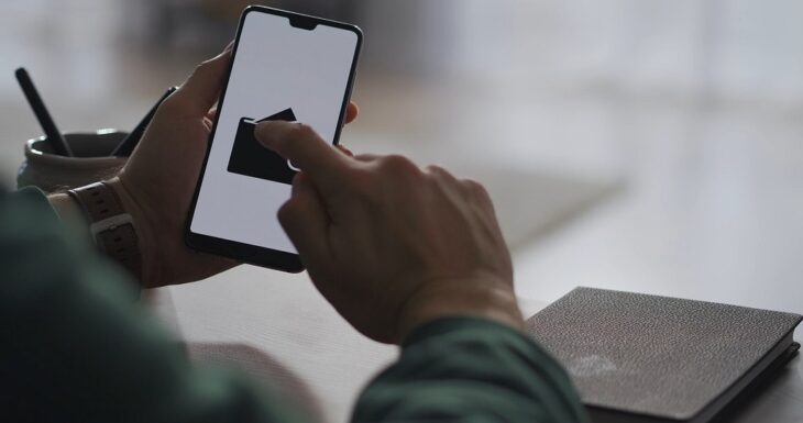 Person using a smartphone with a digital wallet app open on screen