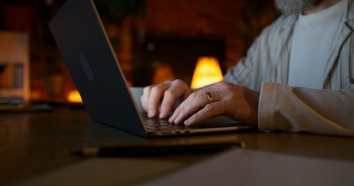Close-up of a person working on a laptop in a dimly lit room, representing responsibilities of handling personal data in line with GDPR
