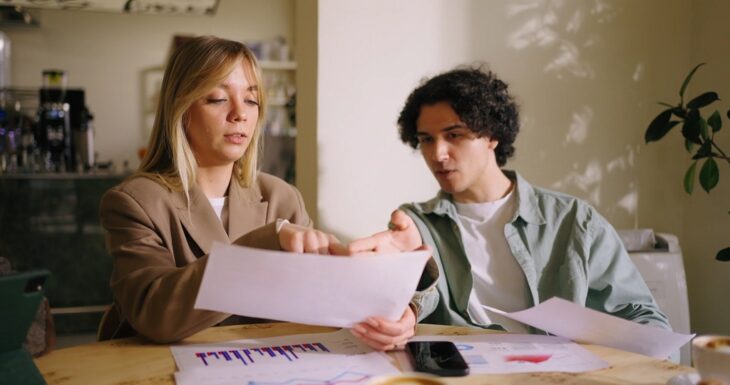 Young professionals analyzing business growth charts at a casual meeting