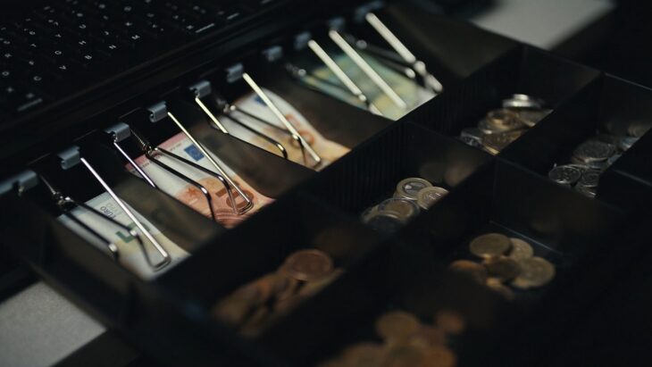 Open cash drawer showing euros and coins, part of a rented POS system in retail