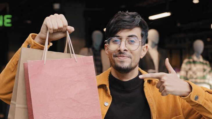 Happy customer showing shopping bags earned through loyalty programs