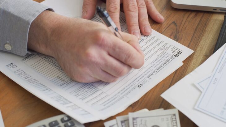 Filling out tax forms to avoid legal and financial mistakes in business