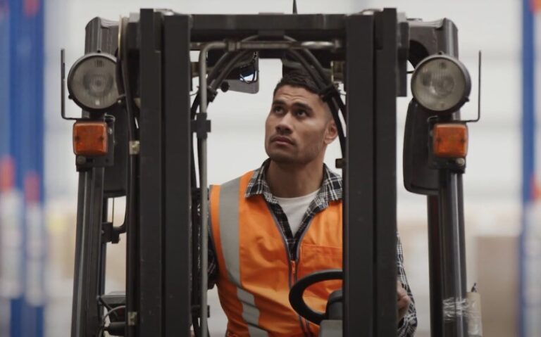 Focused forklift operator in a warehouse setting