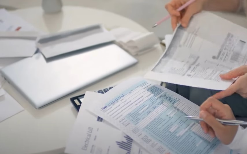 Individuals reviewing tax documents and financial statements