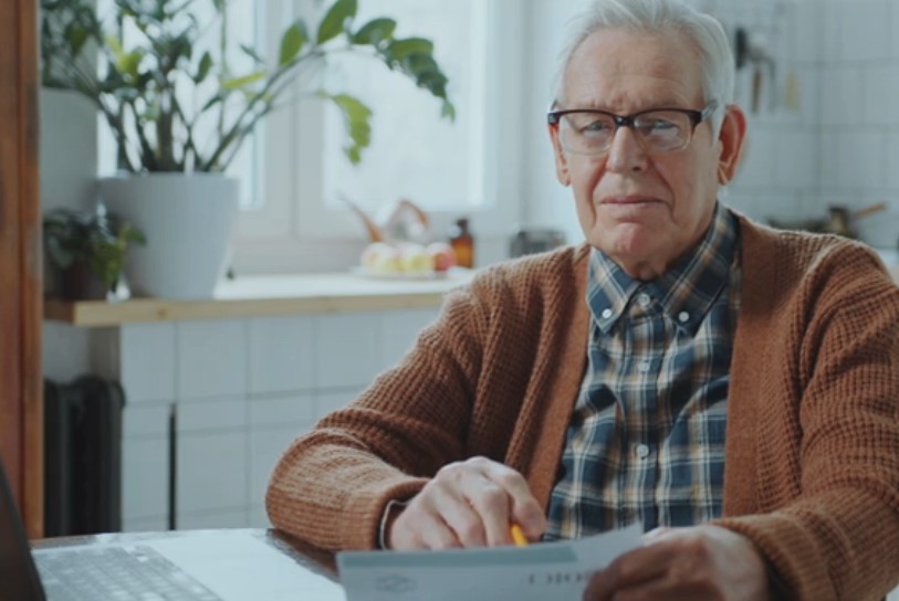 Elderly man reviewing financial documents