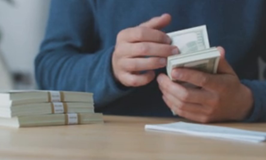 Man counting money at the table