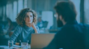 Two professionals having a focused discussion in an office setting