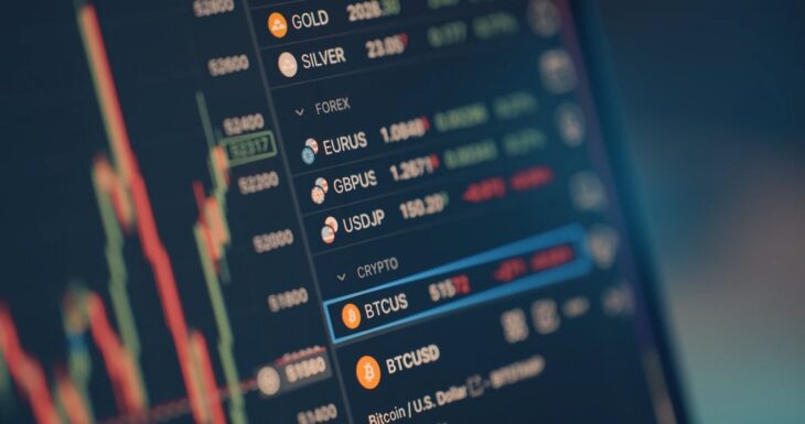 Laptop and phone showing trading charts with AI pattern analysis