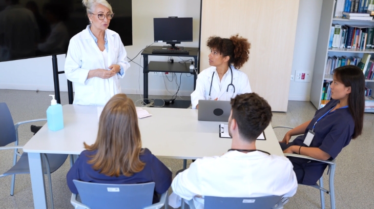 Healthcare leaders and clinical staff discuss workforce strategy during a team meeting