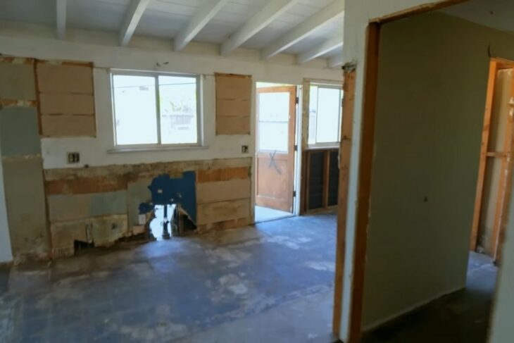 Partially renovated interior with exposed walls and unfinished layout lacking buyer appeal