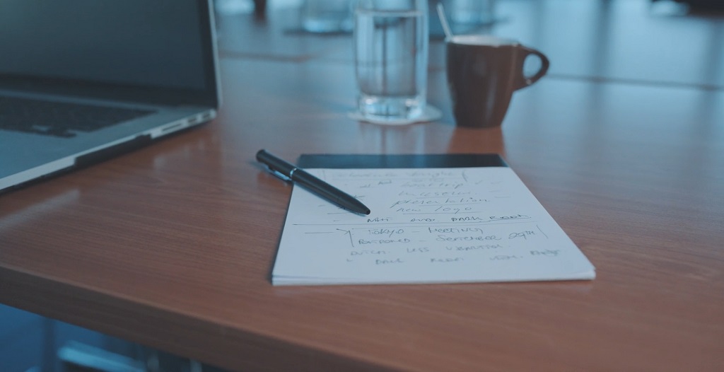 Writing notes while preparing to prepare for business meeting
