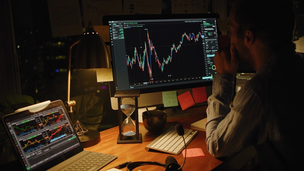 Active trader studying price movements and candlestick charts on a professional trading platform