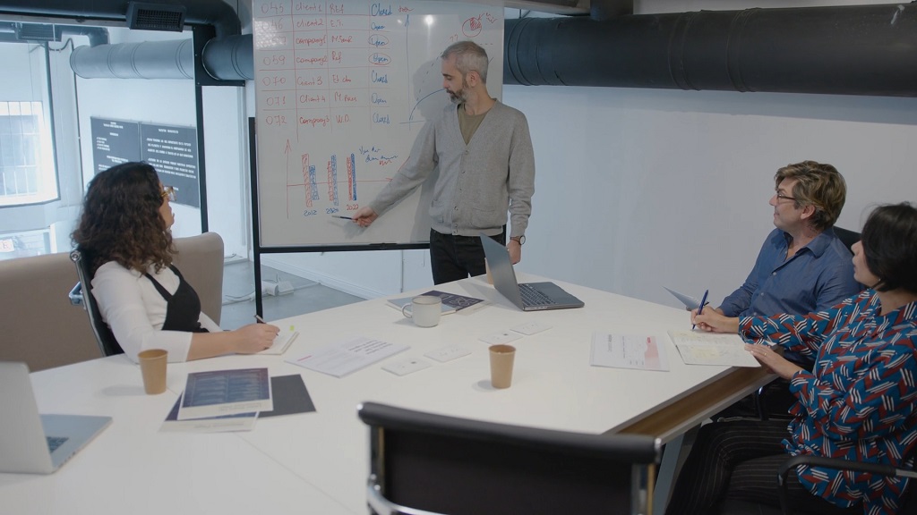 Team reviewing charts while they prepare for business meeting